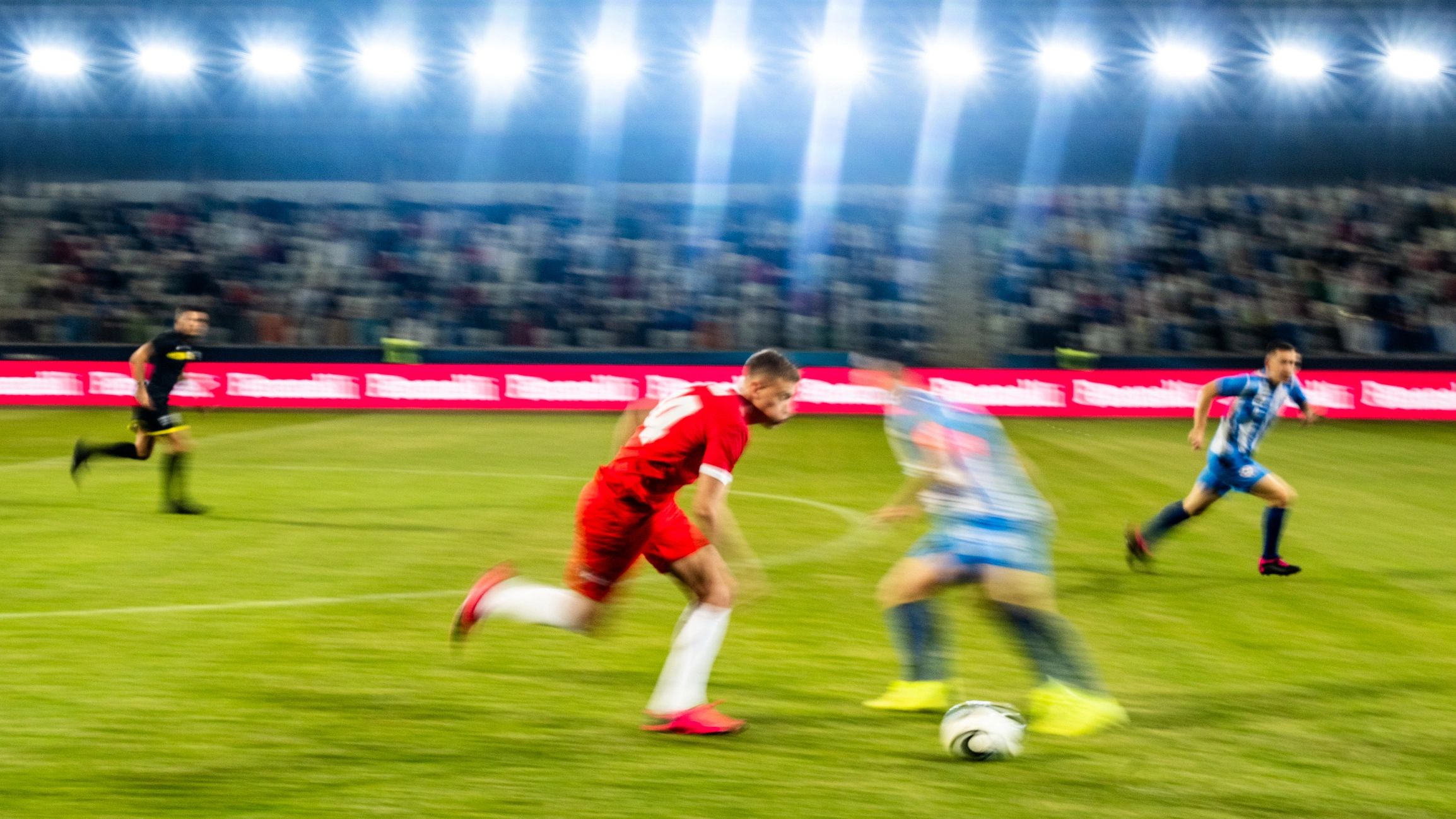 Football players contesting the ball during a match