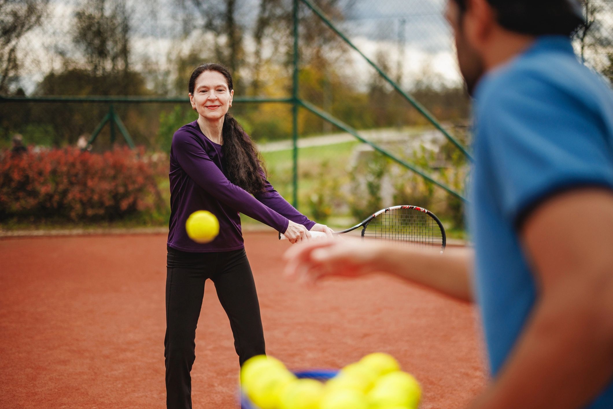 Tennis player practicing a backhand on court