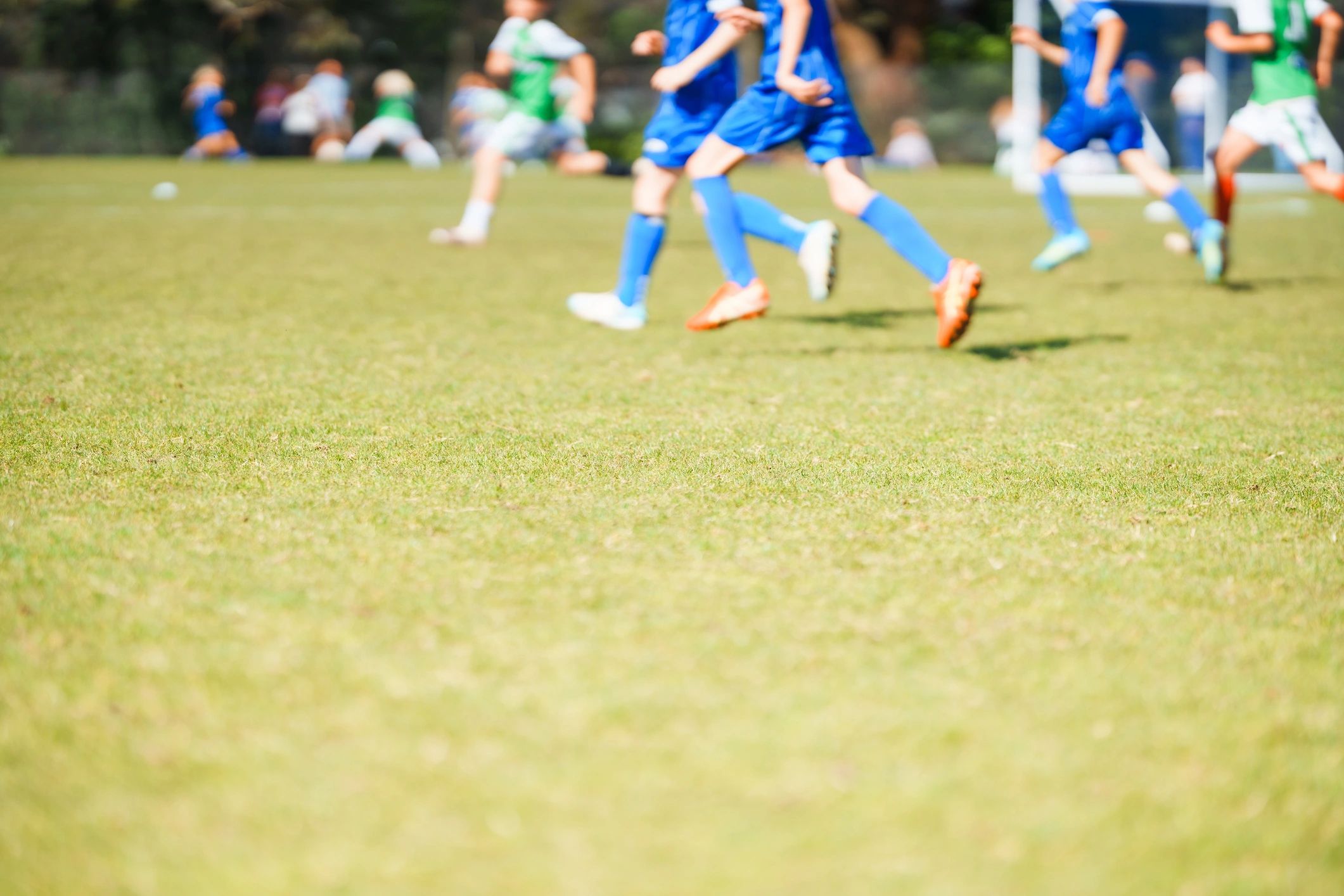 Football match action on a grass pitch