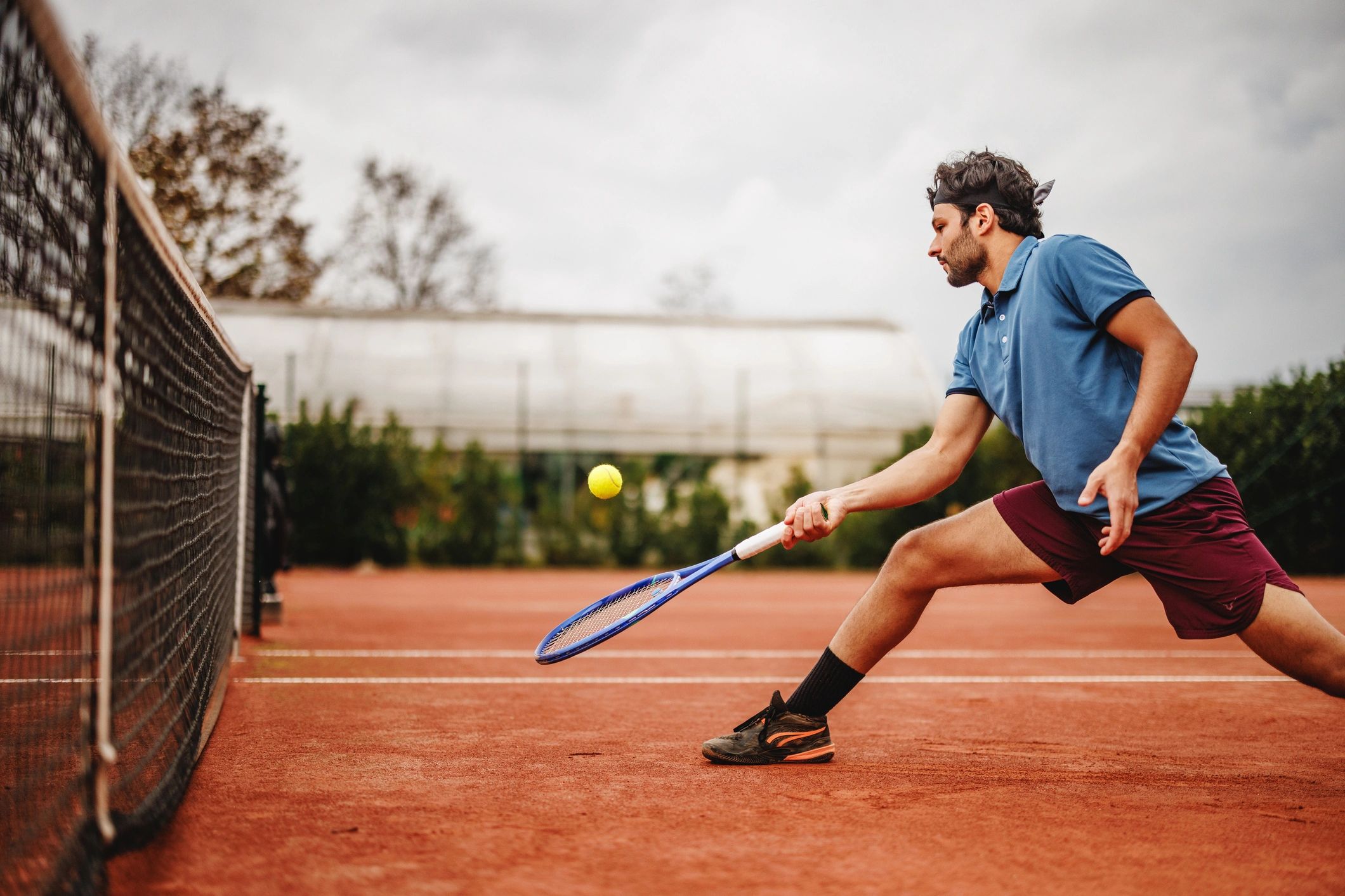 Tennis player competing on a clay court